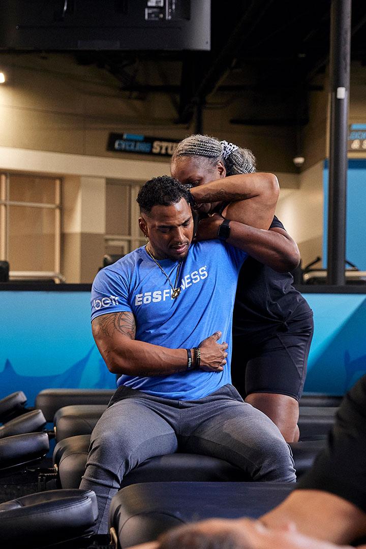 eos staff stretching out a members shoulder
